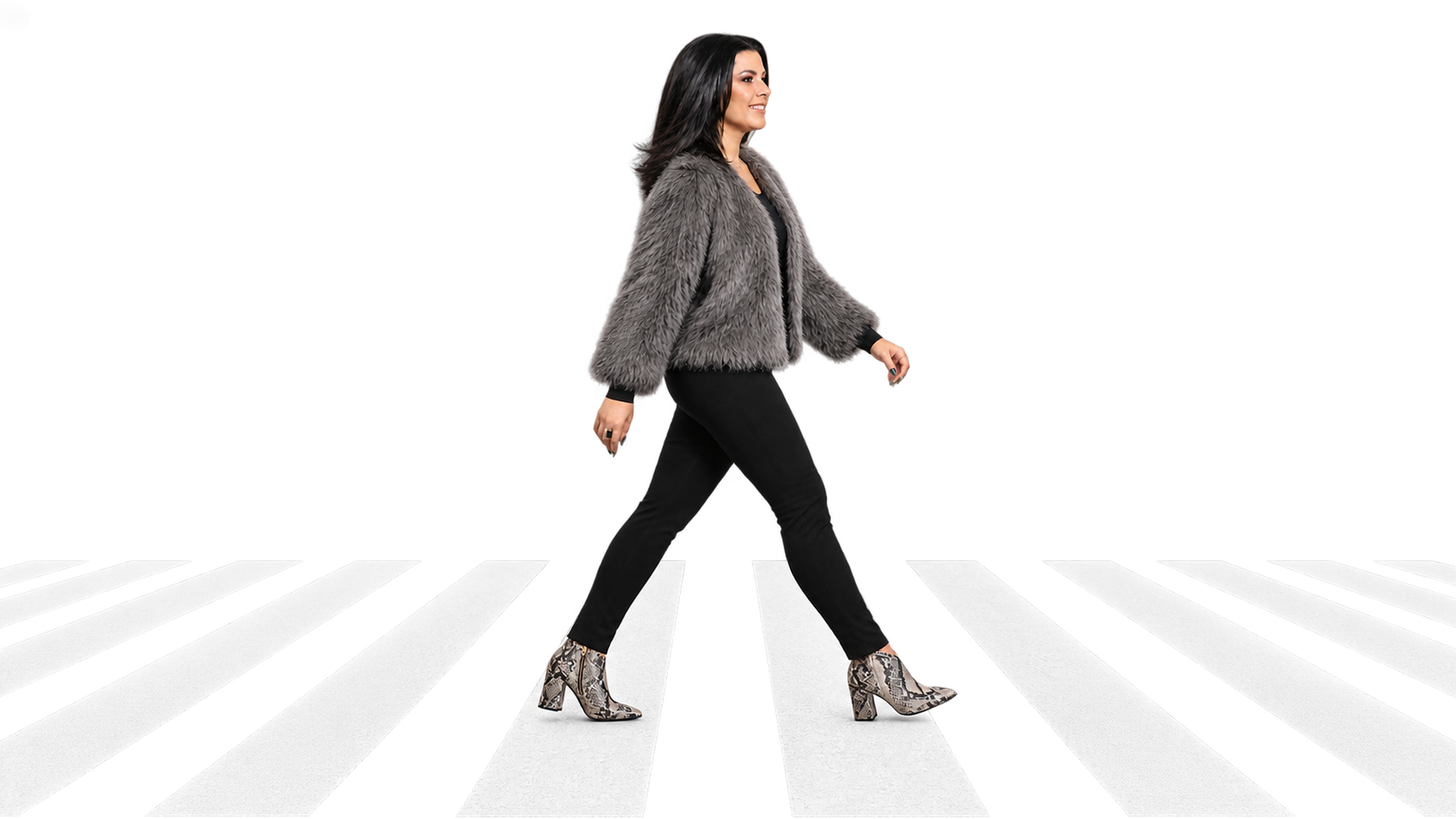 Nora walking across a white crosswalk